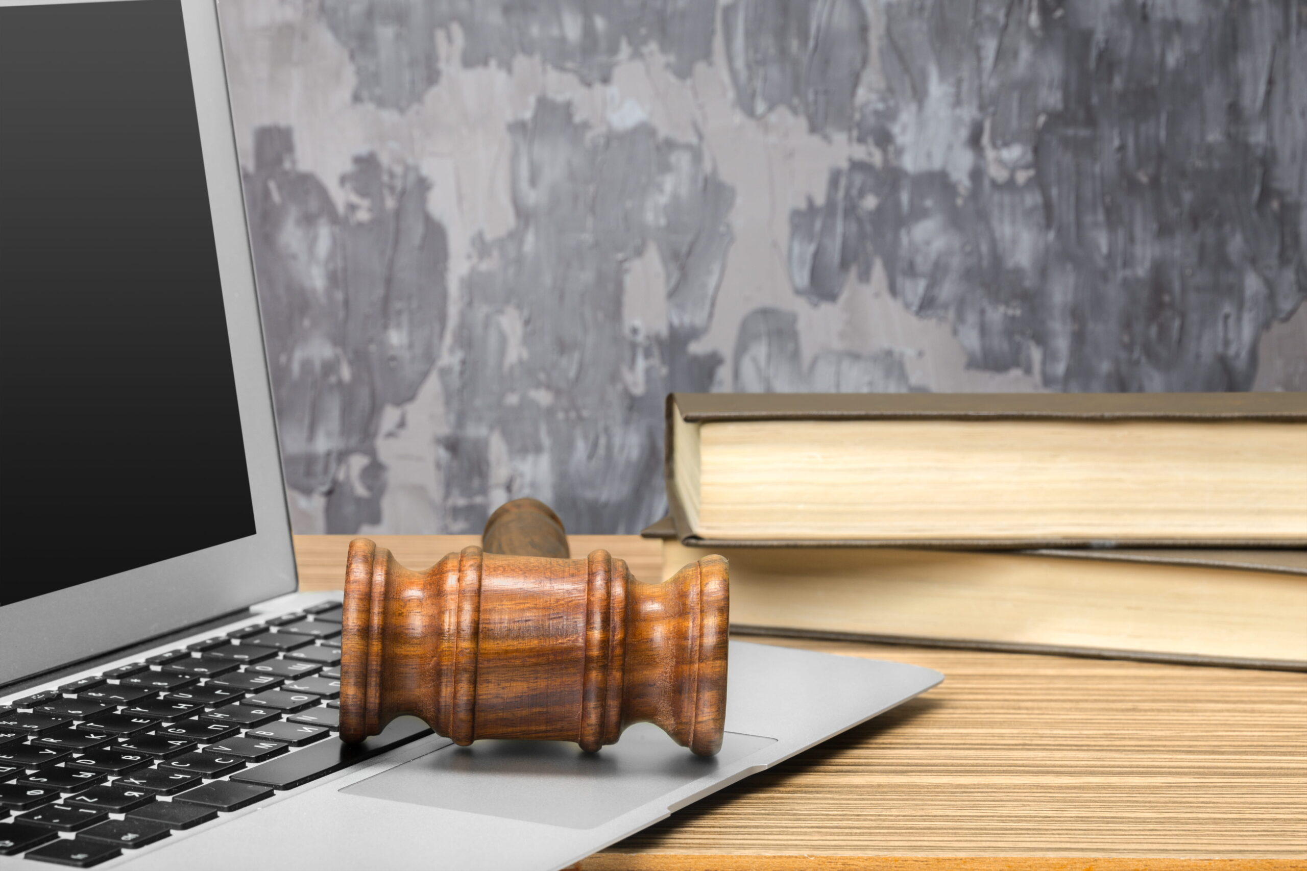 Judge's gavel resting on a laptop beside legal books, representing SEO strategies and digital marketing for mass tort law firms.